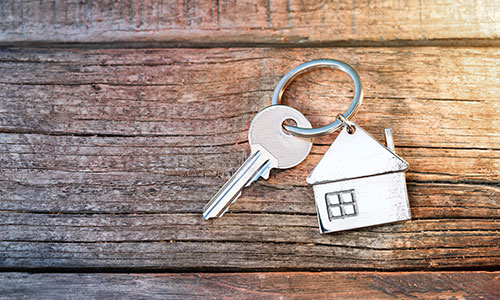 A key on a house-shaped keychain