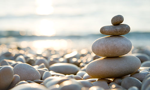 A stack of four stones on a stoney beach